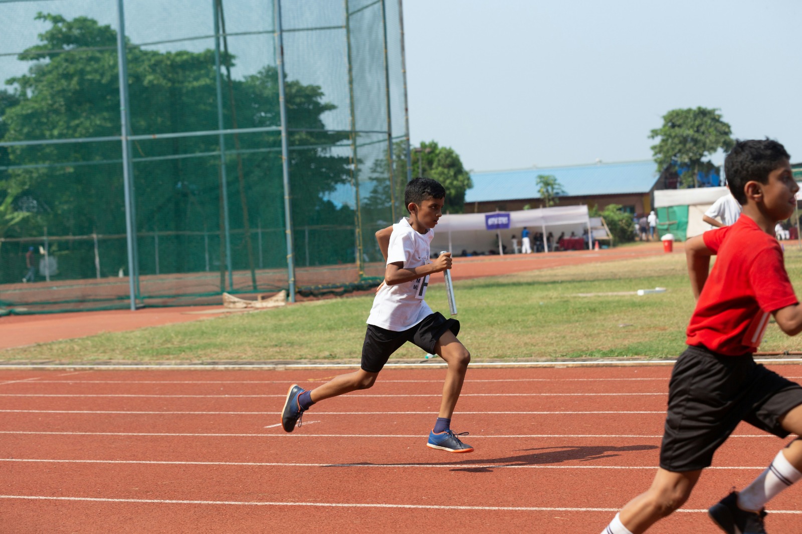 Young athlete running on track